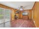 Wood-paneled den with ceiling fan and sliding doors to the outdoor patio at 1933 Silvastone Dr, Decatur, GA 30033