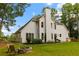 A sprawling backyard features a cozy fire pit and ample space for outdoor activities in a serene, tree-lined setting at 3545 Silver Vista Ct, Cumming, GA 30041