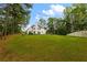 Expansive backyard featuring a lush green lawn and wooded perimeter, perfect for outdoor activities and relaxation at 3545 Silver Vista Ct, Cumming, GA 30041