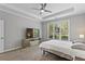 Bedroom showcases a large window, tray ceilings, and a ceiling fan at 3545 Silver Vista Ct, Cumming, GA 30041