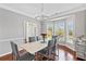 Dining room with hardwood floors, large windows, crown molding, and modern lighting fixtures at 3545 Silver Vista Ct, Cumming, GA 30041