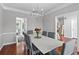 Bright dining room with hardwood floors, decorative molding, contemporary lighting, and neutral paint at 3545 Silver Vista Ct, Cumming, GA 30041