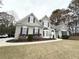 Charming gray home with a well-manicured lawn, complemented by black shutters and stylish architectural details at 3545 Silver Vista Ct, Cumming, GA 30041