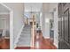 Bright foyer features a staircase, wood floors, natural light from the oversized windows, and an entry door at 3545 Silver Vista Ct, Cumming, GA 30041