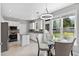 Bright kitchen featuring white cabinets, stainless steel appliances, a granite island, and a breakfast nook at 3545 Silver Vista Ct, Cumming, GA 30041