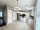 Spacious eat-in kitchen with stainless steel appliances, white cabinets, a granite island and pendant lighting at 3545 Silver Vista Ct, Cumming, GA 30041