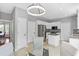 Bright kitchen boasts white cabinets, stainless steel appliances, granite countertops, and a modern lighting fixture at 3545 Silver Vista Ct, Cumming, GA 30041
