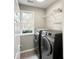 Convenient laundry room with modern washer and dryer and a large window at 3545 Silver Vista Ct, Cumming, GA 30041