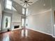 Living room with a fireplace, high ceilings, hardwood floors, and neutral paint at 3545 Silver Vista Ct, Cumming, GA 30041