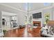 Open-concept living room has a fireplace, wood floors, high ceilings, and an abundance of natural light at 3545 Silver Vista Ct, Cumming, GA 30041