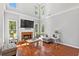 Spacious living room features a fireplace, hardwood floors, plenty of natural light, and neutral tones at 3545 Silver Vista Ct, Cumming, GA 30041