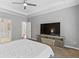 Large main bedroom features a TV, carpet, neutral tones, tray ceilings, and an adjacent bathroom at 3545 Silver Vista Ct, Cumming, GA 30041