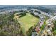 Expansive aerial view featuring a large field and beautiful homes nestled within a well-established neighborhood at 6635 Canyon Cv, Cumming, GA 30028