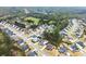 Aerial view showing a community with well-maintained homes, green spaces, and organized street layouts at 6635 Canyon Cv, Cumming, GA 30028