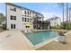 Back of the house, overlooking a swimming pool, lounge chairs, and a well-maintained lawn at 6635 Canyon Cv, Cumming, GA 30028