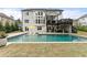 Stunning backyard pool featuring an umbrella table and a two-story deck, perfect for outdoor relaxation and entertaining at 6635 Canyon Cv, Cumming, GA 30028