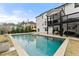 Relaxing backyard pool with lounge chairs and a spacious patio, ideal for enjoying sunny days and outdoor gatherings at 6635 Canyon Cv, Cumming, GA 30028