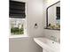Well-lit bathroom features a black framed mirror and window at 6635 Canyon Cv, Cumming, GA 30028