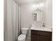 Neutral toned bathroom with vanity, mirror and shower with curtain at 6635 Canyon Cv, Cumming, GA 30028