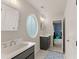 Bright bathroom with double vanity, oval window and tile flooring at 6635 Canyon Cv, Cumming, GA 30028