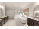 Bright bathroom featuring double vanity, soaking tub, and glass shower with subway tile at 6635 Canyon Cv, Cumming, GA 30028