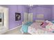 Bedroom with carpet, purple walls, chandelier, bed, and two closets at 6635 Canyon Cv, Cumming, GA 30028