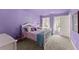 Bedroom with carpet, purple walls, chandelier, and bed at 6635 Canyon Cv, Cumming, GA 30028