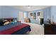 Bright blue bedroom with carpet, two windows and interior door at 6635 Canyon Cv, Cumming, GA 30028