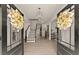 Inviting foyer with elegant double doors and a view of the staircase at 6635 Canyon Cv, Cumming, GA 30028