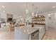 Bright and open kitchen featuring a large island, white cabinetry, and stainless steel appliances at 6635 Canyon Cv, Cumming, GA 30028