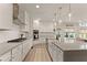A modern kitchen with stainless steel appliances, a large island, and sleek countertops at 6635 Canyon Cv, Cumming, GA 30028