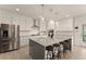 A beautifully designed kitchen featuring stainless steel appliances, a large island, and sleek countertops at 6635 Canyon Cv, Cumming, GA 30028