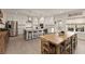 Gourmet kitchen featuring stainless steel appliances, an island with bar stool seating, and a dining area at 6635 Canyon Cv, Cumming, GA 30028