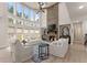 Bright, open living room with a brick fireplace, large windows, and high ceilings at 6635 Canyon Cv, Cumming, GA 30028