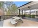 Covered patio featuring a picnic table with seating, overlooking trees at 6635 Canyon Cv, Cumming, GA 30028
