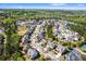 A high-angle shot shows a subdivision with mature trees, tennis courts and a pool at 2195 Well Springs Dr, Buford, GA 30519