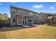 Wide open backyard featuring a patio area with outdoor seating and a wooden playset at 2195 Well Springs Dr, Buford, GA 30519