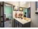 Stylish bathroom vanity with decorative accents and a glimpse into a playroom, inviting Gathering living at 2195 Well Springs Dr, Buford, GA 30519