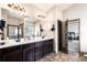 Bathroom boasts a double sink vanity with dark cabinets, and a view into the bedroom at 2195 Well Springs Dr, Buford, GA 30519