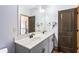 Well-lit bathroom featuring double sinks, gray vanity, white countertops, and modern fixtures at 2195 Well Springs Dr, Buford, GA 30519