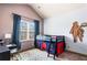 bedroom with a loft bed, desk and study area, and a large window at 2195 Well Springs Dr, Buford, GA 30519