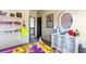 Charming bedroom featuring a dresser with crystal knobs, decorative mirror, and a shelf with books and accessories at 2195 Well Springs Dr, Buford, GA 30519