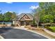 Attractive clubhouse with stone and brown wood accents, professionally landscaped at 2195 Well Springs Dr, Buford, GA 30519