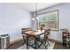 Cozy dining area with a rustic table, chairs, pendant lighting, and view of the backyard through a window at 2195 Well Springs Dr, Buford, GA 30519
