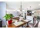 Dining room view featuring hardwood floors and overhead lighting, and open access to the kitchen at 2195 Well Springs Dr, Buford, GA 30519