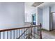 Carpeted upstairs hallway with decorative railing and doorways leading to bedrooms, creating a cozy atmosphere at 2195 Well Springs Dr, Buford, GA 30519