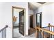 Upstairs hallway featuring doorways to bedrooms and bathrooms, providing seamless transition between living spaces at 2195 Well Springs Dr, Buford, GA 30519