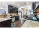 Spacious kitchen featuring granite countertops, stainless steel appliances, and dark cabinetry for a sleek design at 2195 Well Springs Dr, Buford, GA 30519