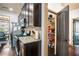 Kitchen with stainless steel appliances, dark brown cabinetry, and open pantry door with view of the dining room at 2195 Well Springs Dr, Buford, GA 30519