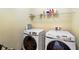 Functional laundry room with modern Samsung washer and dryer, plus a shelf for storage at 2195 Well Springs Dr, Buford, GA 30519